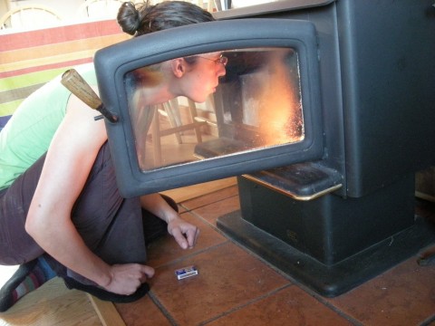 Maria tending the wood stove, Twisp, WA, October 2009